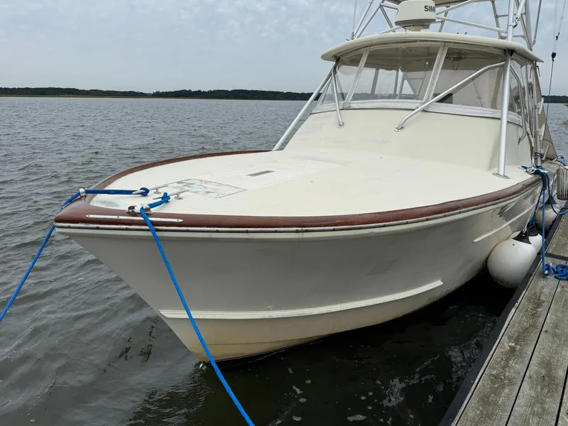 Slide: The Image of Custom Stardust 32 Express boat, 2005 model, docked on calm water. - 3