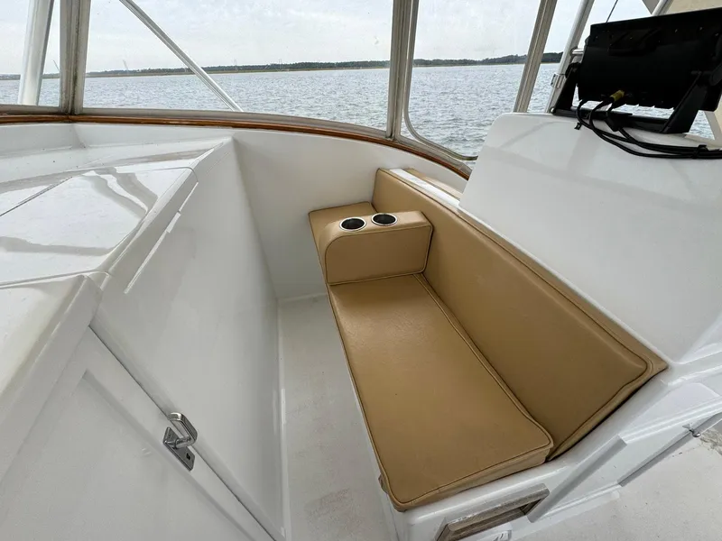 Slide: The Image of Beige seating area on 2005 Custom Stardust 32 Express boat with cup holders. - 32
