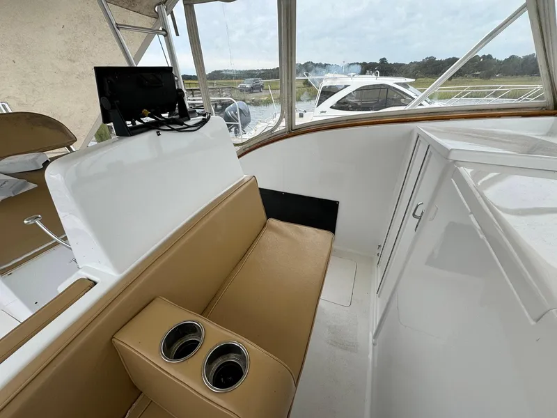 Slide: The Image of Interior of 2005 Custom Stardust 32 Express boat with tan seating and cup holders. - 33