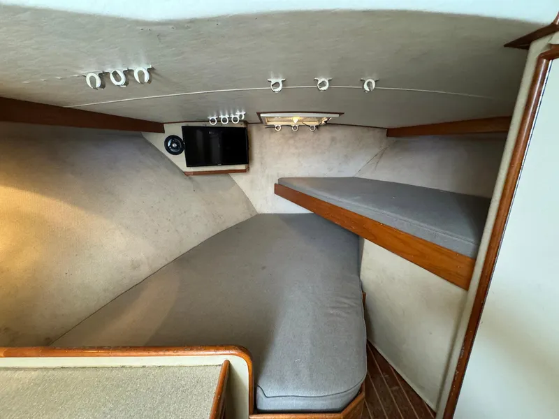 Slide: The Image of Interior cabin of 2005 Custom Stardust 32 Express with bunk beds and cozy seating. - 35