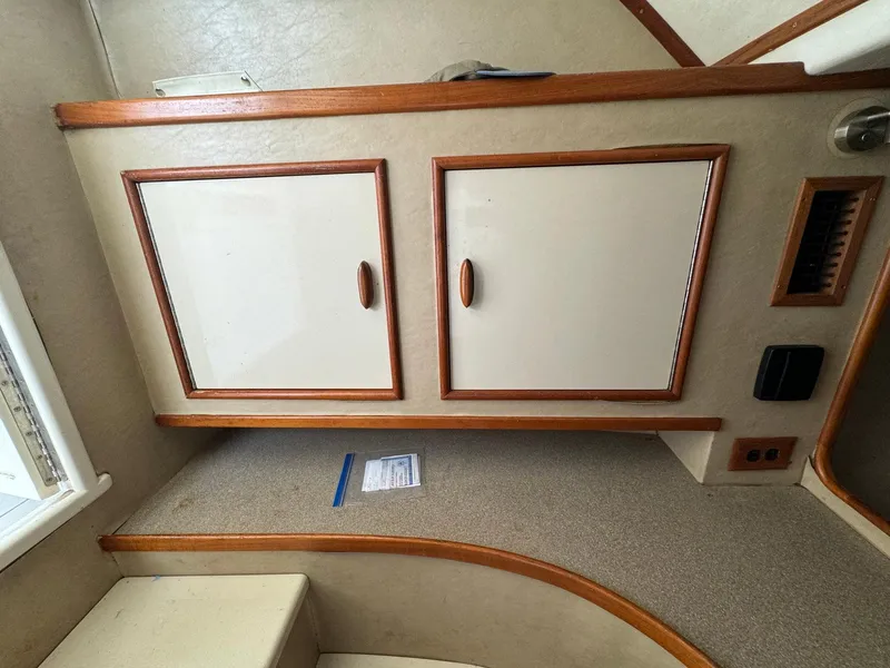 Slide: The Image of Interior of 2005 Custom Stardust 32 Express boat with wooden cabinets and countertop. - 36