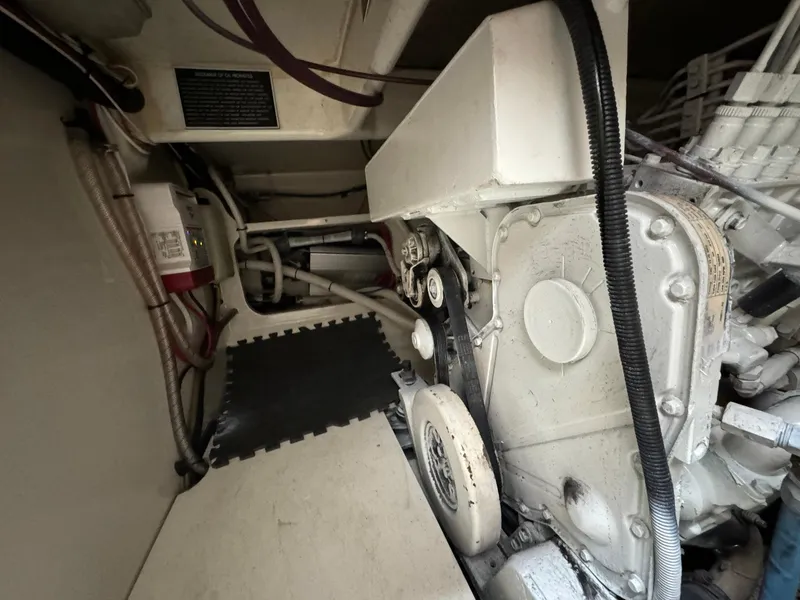 Slide: The Image of Engine room of 2005 Custom Stardust 32 Express with visible machinery and fire extinguisher. - 45