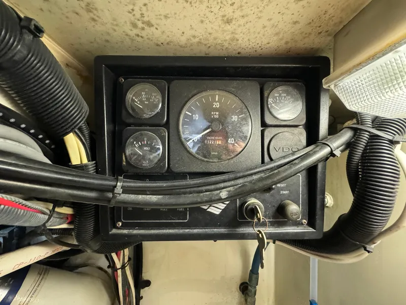 Slide: The Image of Control panel of a 2005 Custom Stardust 32 Express boat with gauges and wiring. - 46