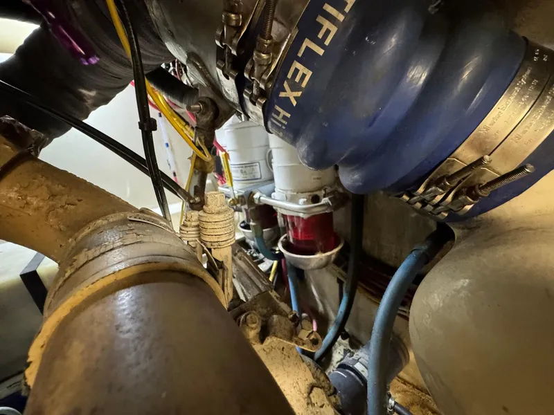 Slide: The Image of Engine compartment of 2005 Custom Stardust 32 Express with hoses and mechanical components. - 47