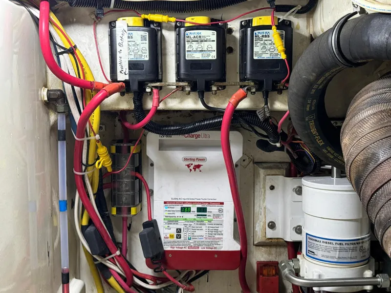 Slide: The Image of Electrical components and wiring inside a 2005 Custom Stardust 32 Express boat. - 48