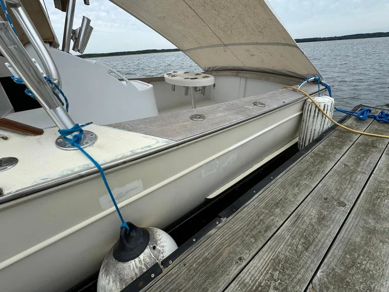 Slide: The Image of Custom Stardust 32 Express boat docked, 2005 model, with canopy and fender, on a wooden pier. - 5