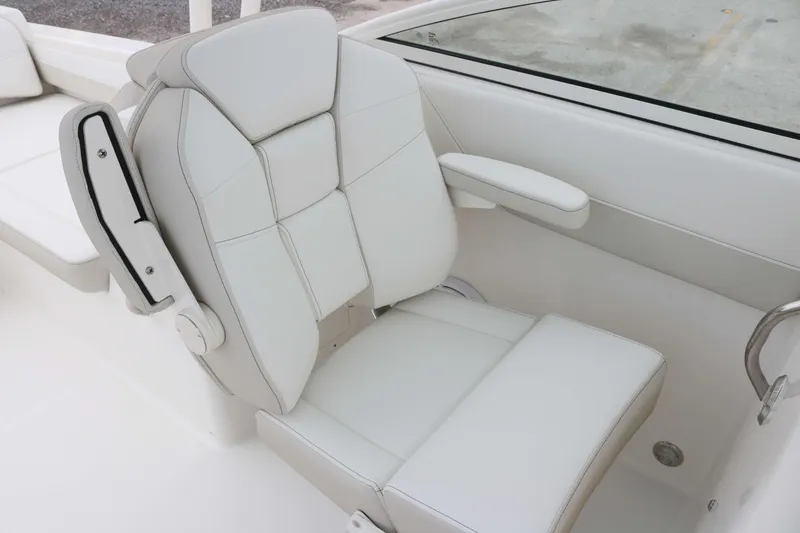 Slide: The Image of White leather seat on 2025 World Cat 230 SD boat, featuring armrests and modern design. - 10