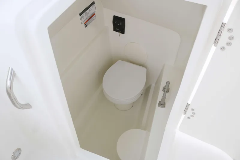 Slide: The Image of 2025 World Cat 230 SD boat interior with compact marine toilet. - 11