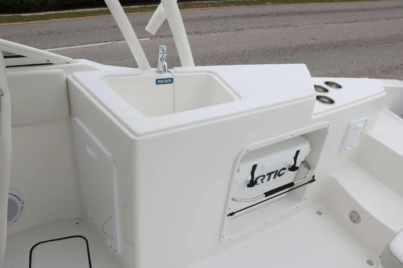 Slide: The Image of 2025 World Cat 230 SD boat interior with sink and storage compartment. - 13