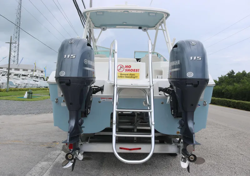 Slide: The Image of 2025 World Cat 230 SD boat with twin Yamaha 115 engines, rear view. - 4