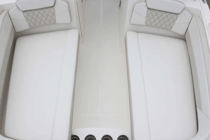 Slide: The Image of Interior seating of 2025 World Cat 230 SD boat, featuring white cushioned seats. - 9
