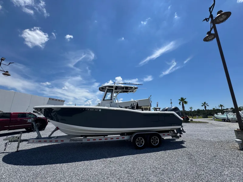 Slide: The Image of 2023 Tidewater 282 CC Adventure Bluewater boat on trailer under clear blue sky. - 10
