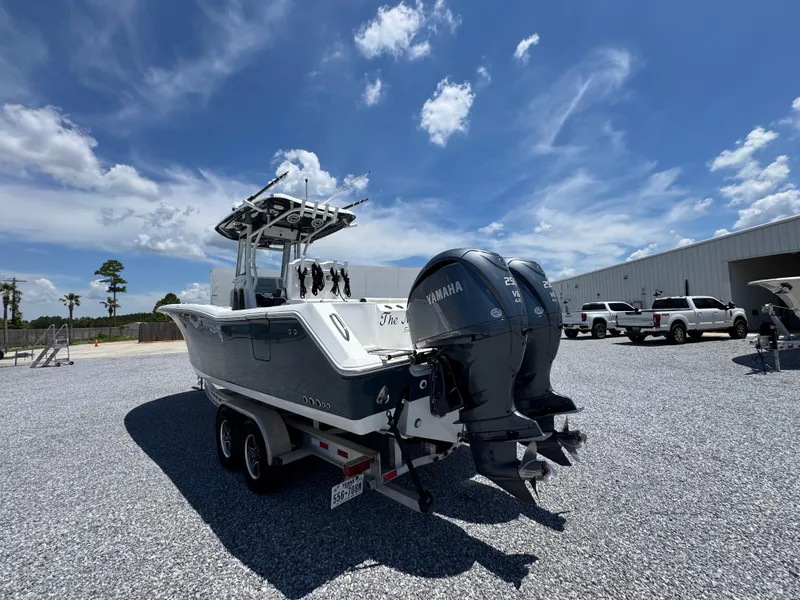 Slide: The Image of 2023 Tidewater 282 CC Adventure Bluewater boat with twin Yamaha engines on a trailer. - 13