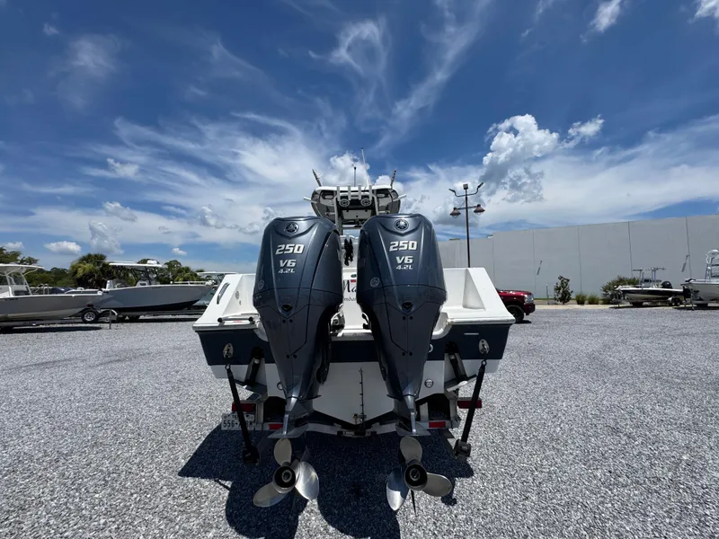 Slide: The Image of 2023 Tidewater 282 CC Adventure Bluewater boat with dual 250 V6 engines, parked outdoors. - 15