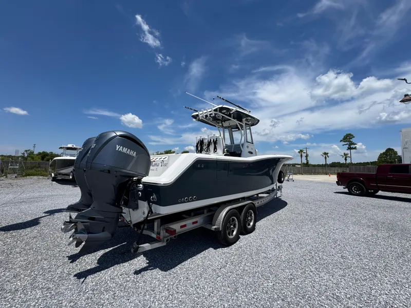 Slide: The Image of 2023 Tidewater 282 CC Adventure Bluewater boat on trailer under clear sky. - 17