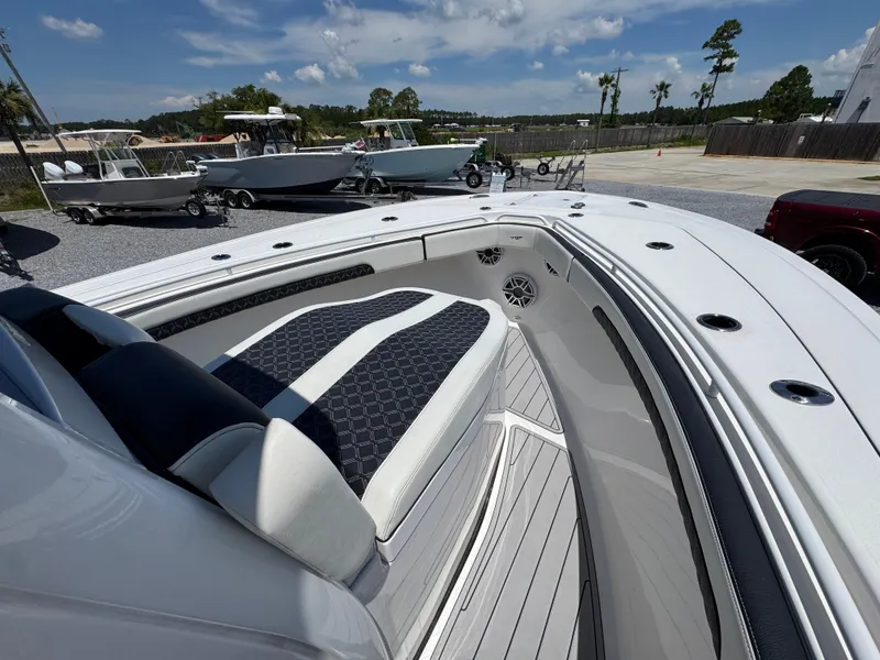 Slide: The Image of 2023 Tidewater 282 CC Adventure Bluewater boat interior with cushioned seating and sleek design. - 18
