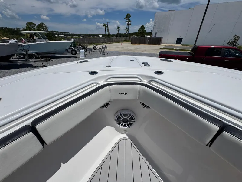 Slide: The Image of 2023 Tidewater 282 CC Adventure Bluewater boat interior with cushioned seating and speaker. - 19