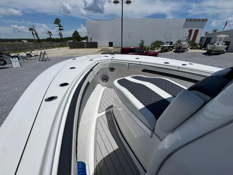 Slide: The Image of 2023 Tidewater 282 CC Adventure Bluewater boat interior with cushioned seating and sleek design. - 20