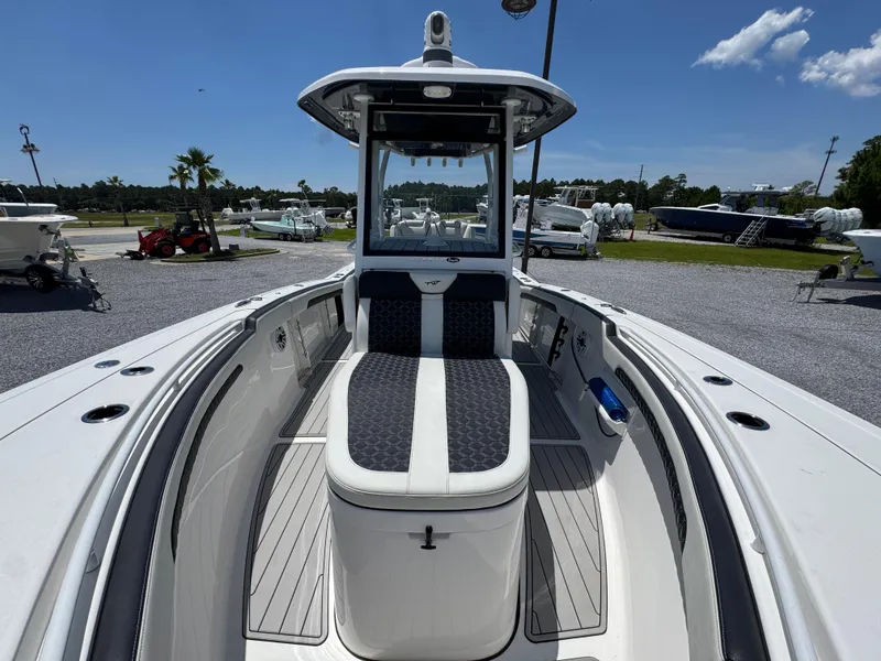 Slide: The Image of 2023 Tidewater 282 CC Adventure Bluewater boat, spacious deck, modern design, outdoor setting. - 23
