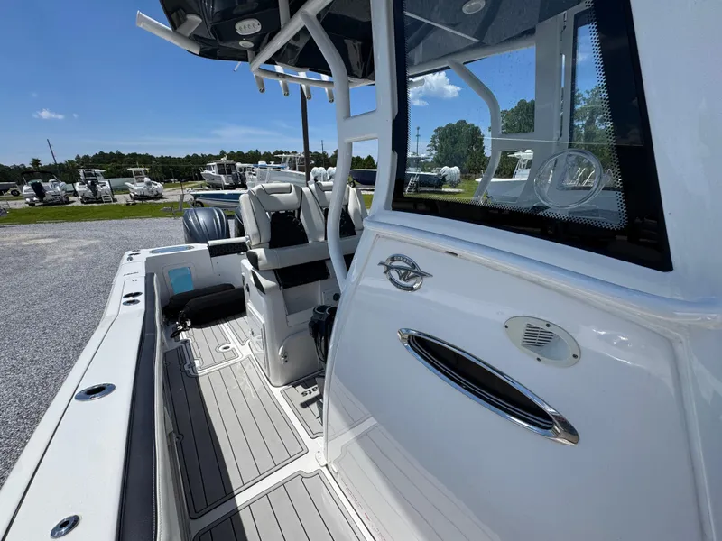 Slide: The Image of 2023 Tidewater 282 CC Adventure Bluewater boat interior with seating and deck view. - 25