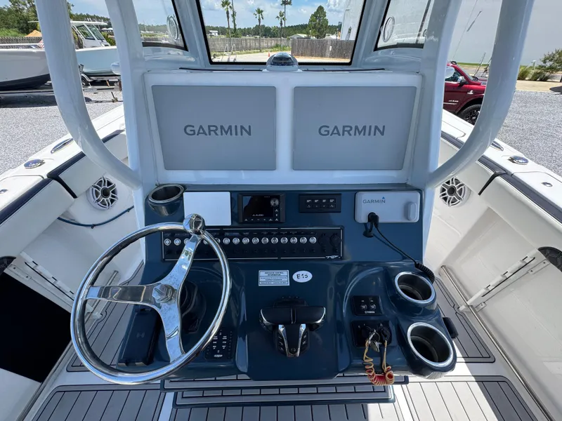 Slide: The Image of 2023 Tidewater 282 CC Adventure Bluewater boat helm with Garmin displays and controls. - 29