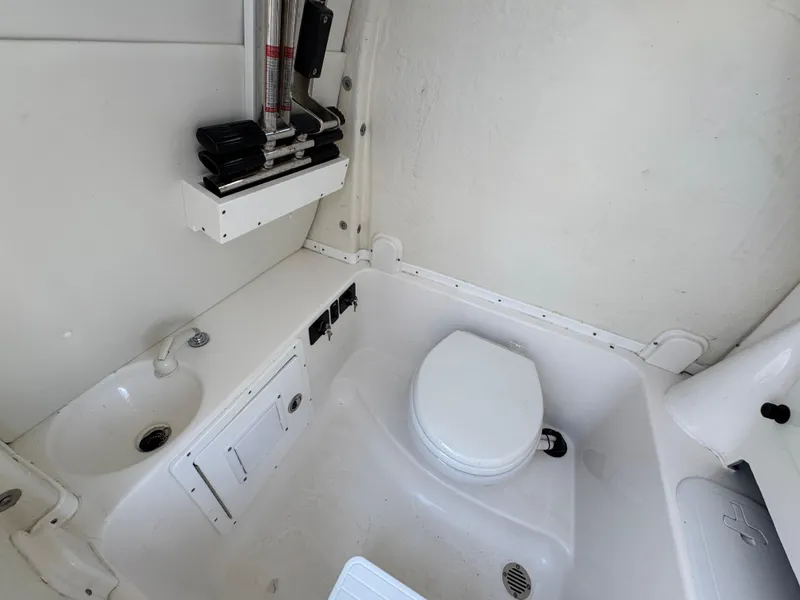 Slide: The Image of 2023 Tidewater 282 CC Adventure Bluewater boat bathroom interior with toilet and sink. - 37