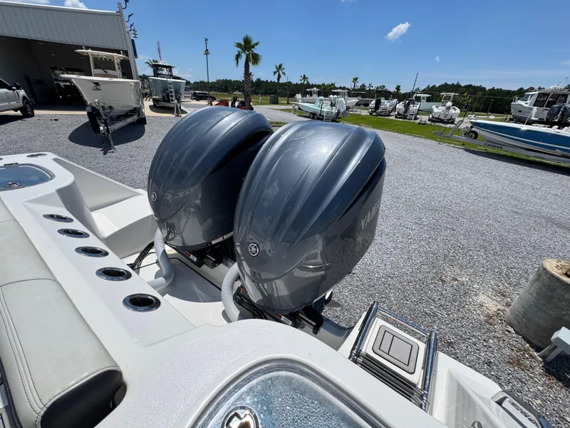 Slide: The Image of 2023 Tidewater 282 CC Adventure Bluewater with dual Yamaha outboard engines in a boatyard. - 41