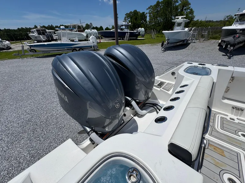 Slide: The Image of 2023 Tidewater 282 CC Adventure Bluewater with dual Yamaha engines in a boatyard setting. - 42
