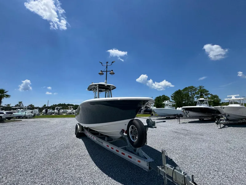 Slide: The Image of 2023 Tidewater 282 CC Adventure Bluewater boat on trailer under clear blue sky. - 5