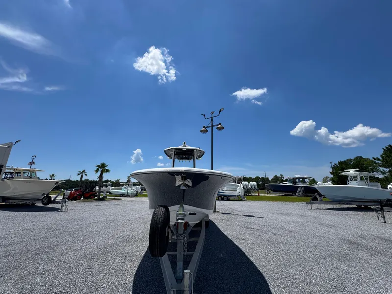 Slide: The Image of 2023 Tidewater 282 CC Adventure Bluewater boat on trailer under clear blue sky. - 6