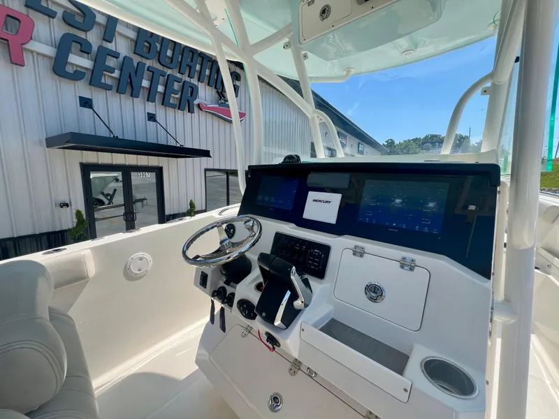 Slide: The Image of 2023 Sailfish 290 CC boat dashboard with modern controls and navigation screens. - 13