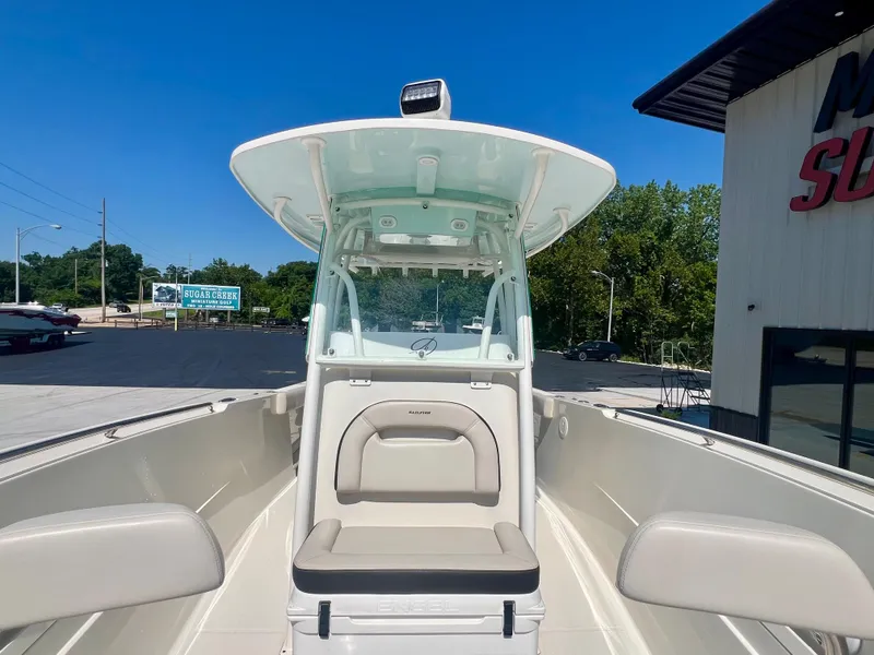 Slide: The Image of 2023 Sailfish 290 CC boat with seating, docked outdoors under clear blue sky. - 16