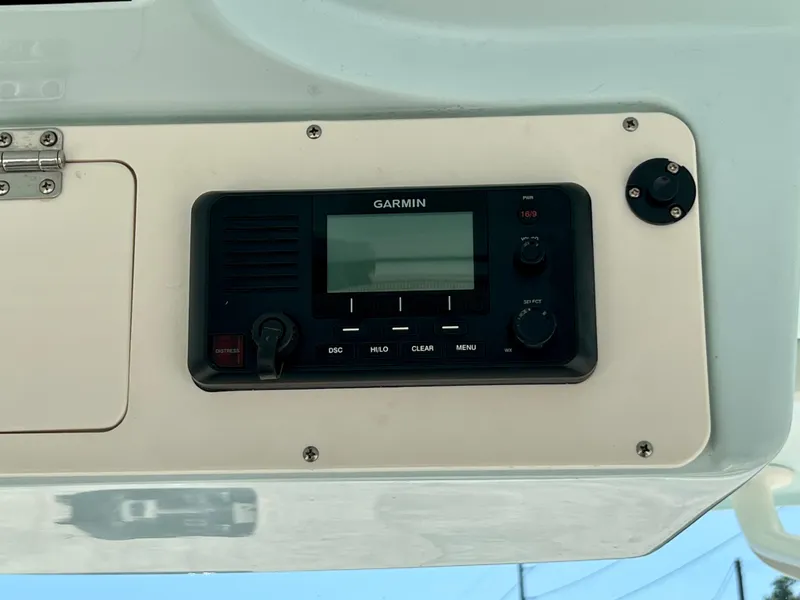 Slide: The Image of Garmin marine radio on 2023 Sailfish 290 CC boat dashboard. - 19