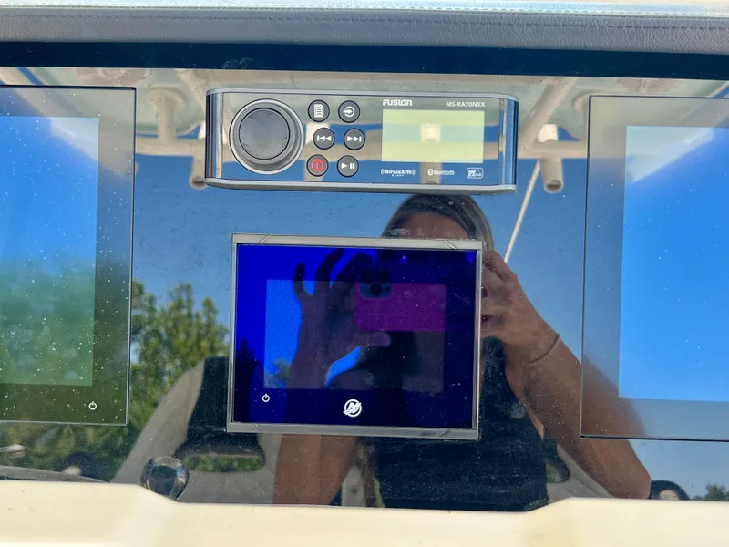 Slide: The Image of Dashboard of 2023 Sailfish 290 CC boat with electronic controls and display screens. - 21