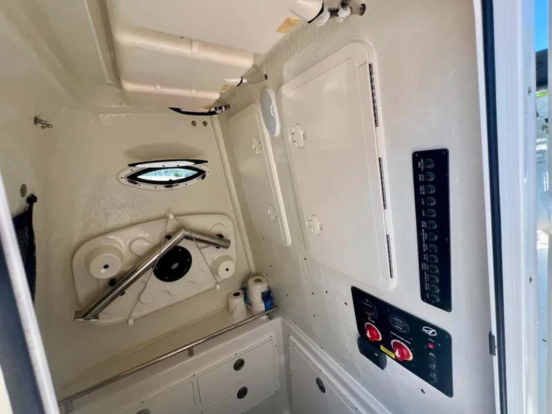 Slide: The Image of Interior of 2023 Sailfish 290 CC boat, featuring control panels and storage compartments. - 24