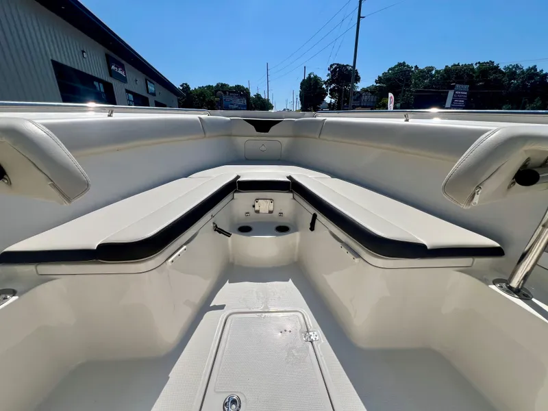 Slide: The Image of 2023 Sailfish 290 CC boat interior with cushioned seating and storage compartments. - 27