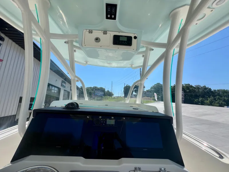 Slide: The Image of 2023 Sailfish 290 CC boat interior with modern dashboard and overhead console. - 29