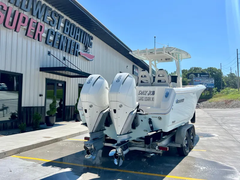 Slide: The Image of 2023 Sailfish 290 CC boat at Midwest Boating Center, featuring dual outboard motors. - 3