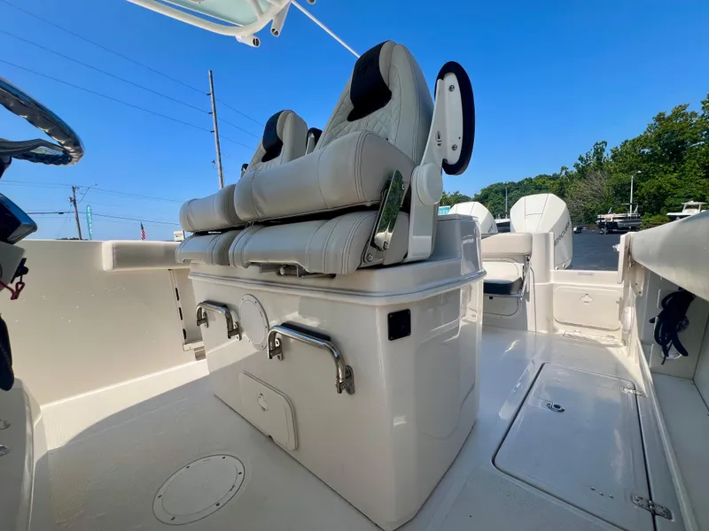 Slide: The Image of 2023 Sailfish 290 CC boat interior with dual seats and storage compartments. - 31