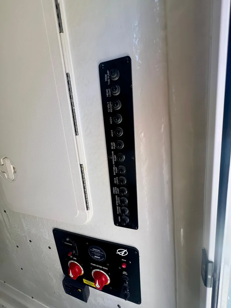 Slide: The Image of Control panel of 2023 Sailfish 290 CC boat, featuring switches and dials. - 34