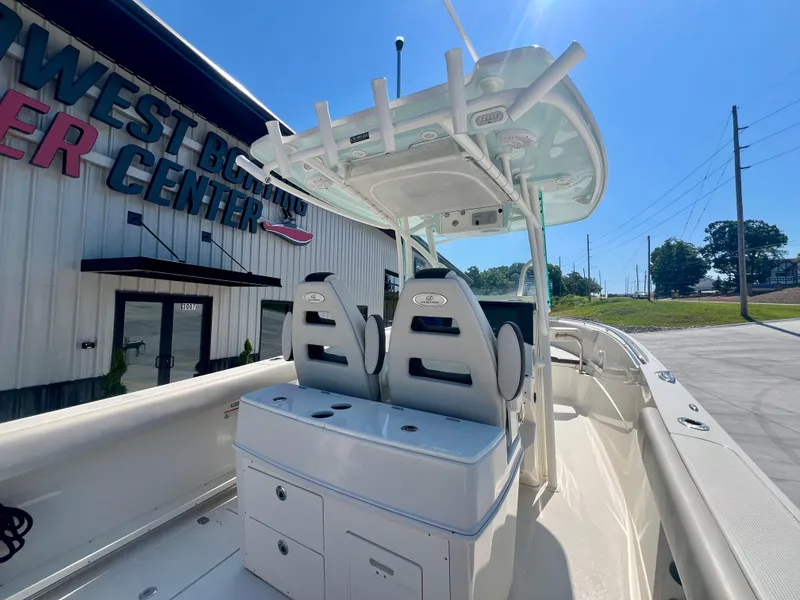 Slide: The Image of 2023 Sailfish 290 CC boat at Northwest Boating Center, showcasing helm and seating area. - 8