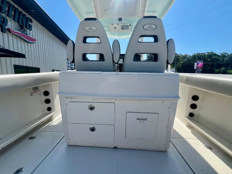 Slide: The Image of 2023 Sailfish 290 CC boat interior with dual seats and storage compartments. - 9
