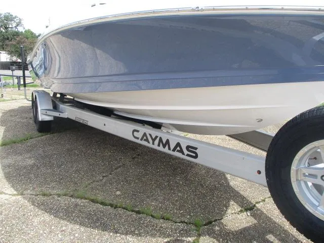 Slide: The Image of 2025 Caymas 26HB boat on trailer, showcasing sleek hull design and branding. - 10