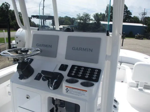 Slide: The Image of 2025 Caymas 26HB boat console with dual Garmin displays and steering wheel. - 5