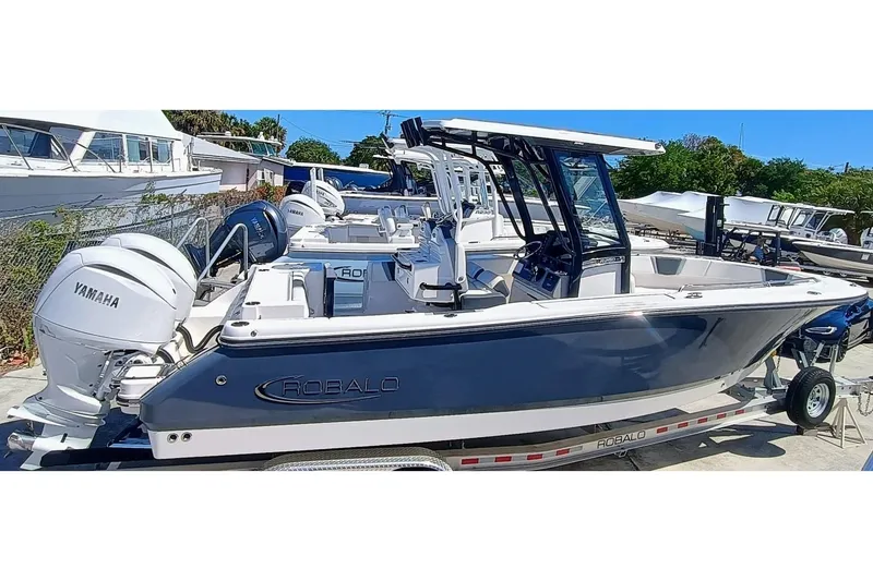 Slide: The Image of 2024 Robalo R250 Center Console boat with Yamaha engines on a trailer. - 0
