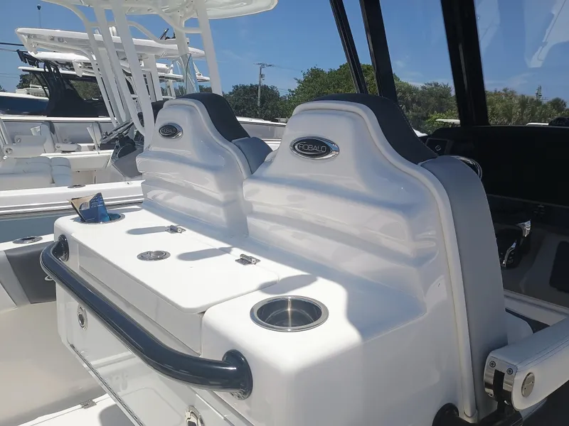 Slide: The Image of 2024 Robalo R250 Center Console boat interior with seating and cup holders. - 11