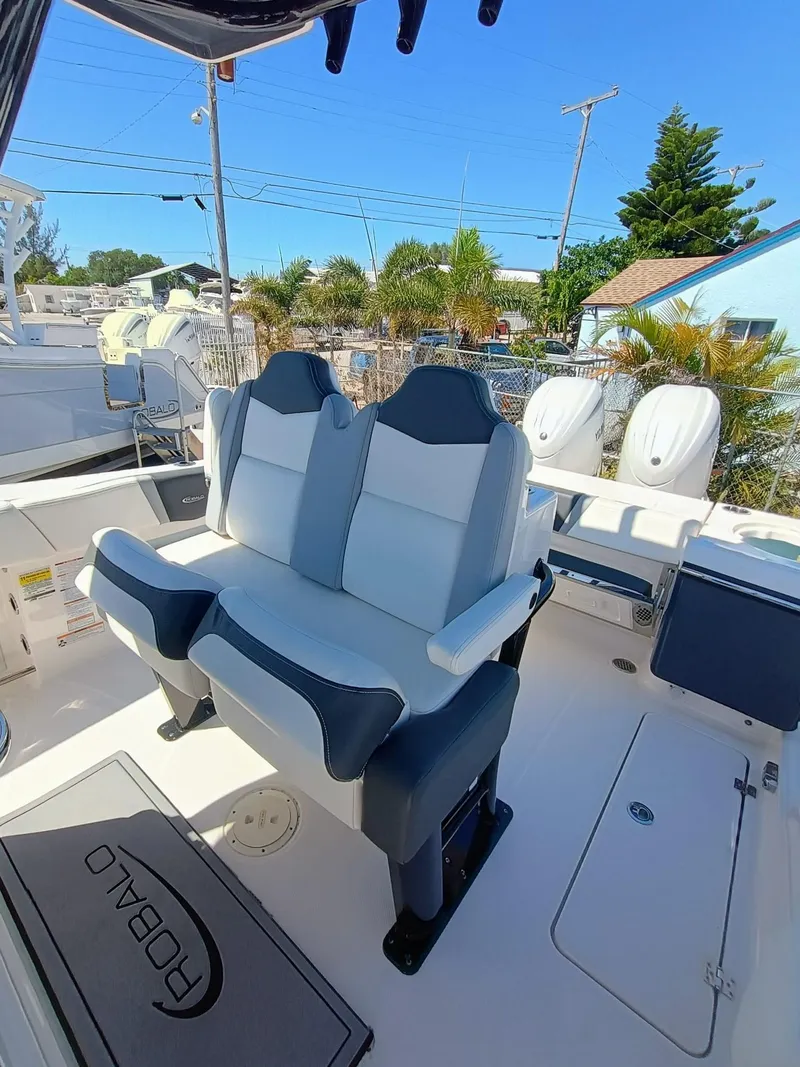Slide: The Image of 2024 Robalo R250 Center Console boat interior with dual seating and outboard motors. - 12