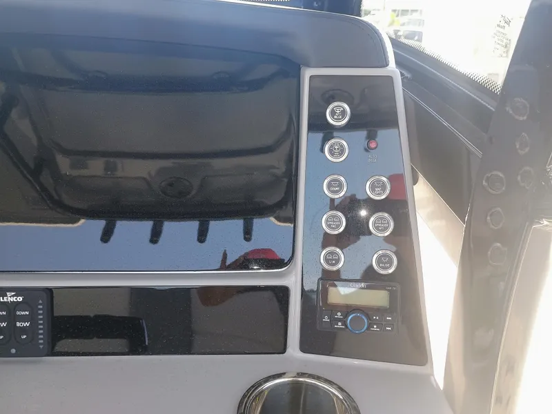 Slide: The Image of 2024 Robalo R250 Center Console dashboard with control panel and buttons. - 13