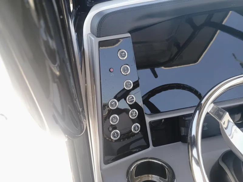 Slide: The Image of 2024 Robalo R250 Center Console dashboard with steering wheel and control panel. - 14