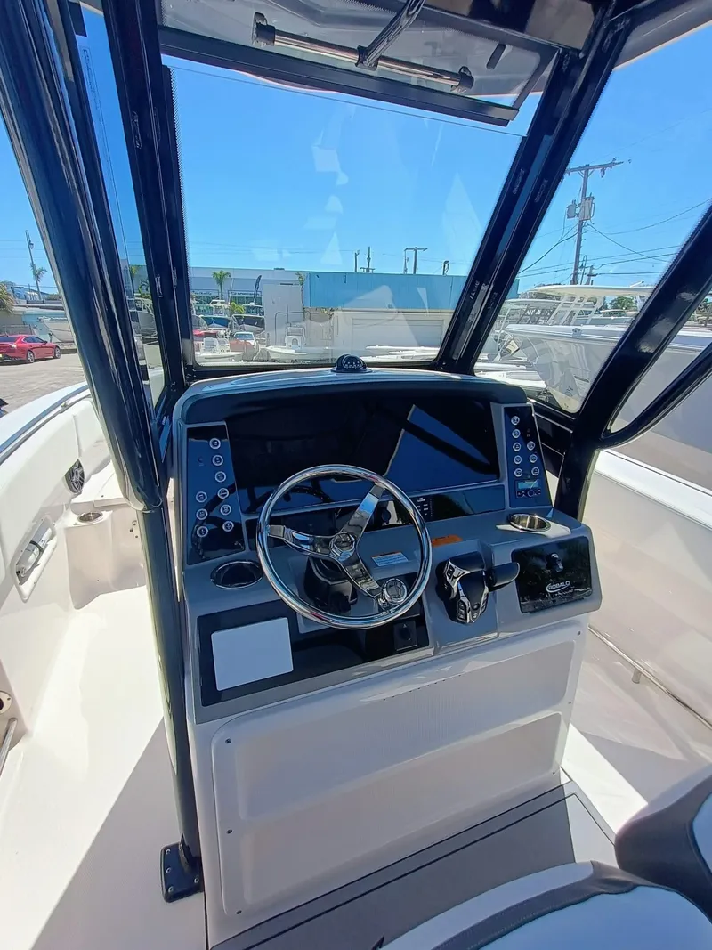 Slide: The Image of 2024 Robalo R250 Center Console boat dashboard with steering wheel and controls. - 15
